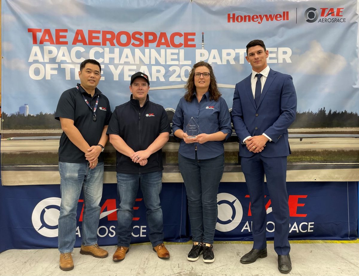 TAE Aerospace Sales representatives accept Honeywell trophy.